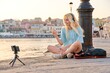 Female teen vlogger recording video using smartphone on tripod