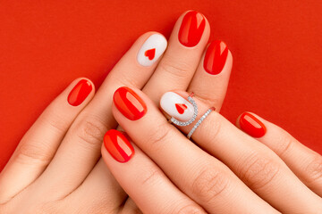 Wall Mural - Womans hands with fashionable red manicure. Valentines day nail design