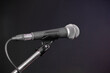 © lmanju - microphone on stand over dark background