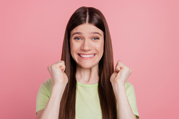 Photo of young cheerful girl happy positive smile rejoice win victory fists hands isolated on shine pink background