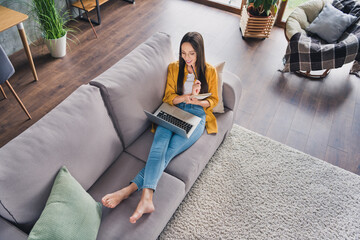 Poster - Top view photo of pretty shiny young lady dressed yellow shirt writing planner working modern gadget smiling indoors room home house