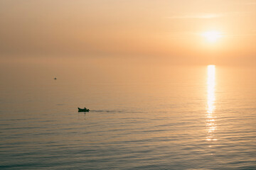 Silhouette of kayaks on the sea during sunset