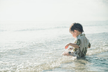 2 years old baby boy playing sand on the beach,Holidays with baby summer concept.