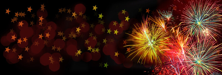 Wall Mural - colorful fireworks on black background with stars and dark red bokeh for christmas, anniversary, new