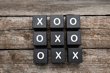 Poster - Tic tac toe cube set on wooden table, flat lay