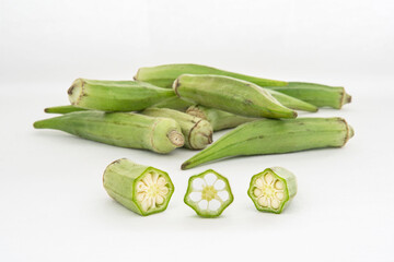 Wall Mural - Small pile of green okra on a white background