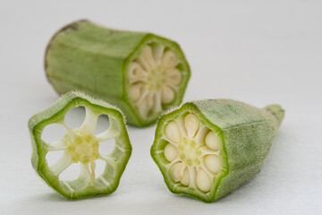 Wall Mural - Small pile of green okra on a white background