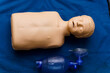 Medical dummy with oxygen mask on blue blanket. Photo from the side. First aid help concept. Close up
