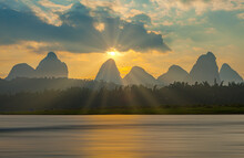 Sunrise Over The Karst Landscape With Jagged Mountains And The Li River At Li Jiang, China