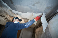 Fire Damage And Restoration Indoor Interior. Removing Damaged Paint Layer