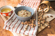 © Alina_Huzova - Healthy, dietary and nutritious oatmeal with hazelnuts in a gray plate on the table top view.