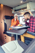 © David Pereiras - Friends having breakfast in a camper van in the morning