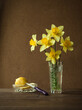 daffodils in a crystal vase. Sliced lemon in a crystal saucer.