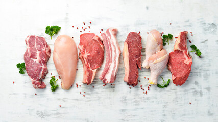 Wall Mural - Banner. Raw meat steaks salmon, beef and chicken on a white wooden background. Organic food. Top view.