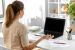© Syda Productions - distant education, remote job and people concept - happy smiling female teacher with laptop computer having video call or online class at home office