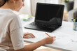 © Syda Productions - education, online school and distant learning concept - student woman with laptop computer drawing picture of cat on paper at home