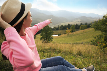 Wall Mural - Young woman enjoying beautiful view of mountain landscape. Space for text