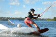 © New Africa - Teenage boy wakeboarding on river. Extreme water sport