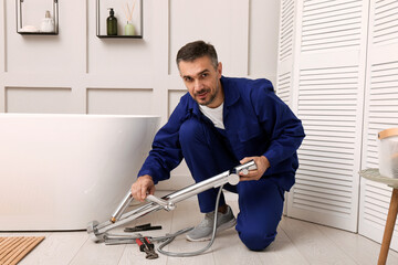 Wall Mural - Professional plumber installing water tap in bathroom