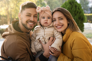 Sticker - Happy parents with their baby in park on sunny day