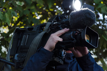 TV CAMERA - Cameraman when recording reportage materials 
