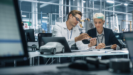 Poster - Two Young Automotive Engineers Working in Office at Car Factory. Industrial Designer and Colleague Discussing Different Applications of a Metal Pinion Gear in Personal Mobility Vehicles.