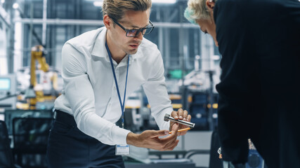 Leinwandbilder - Two Young Automotive Engineers Working in Office at Car Factory. Industrial Designer and Colleague Discussing Different Applications of a Metal Pinion Gear in Personal Mobility Vehicles.