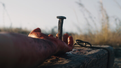 anonymous male executioner performing crucifixion