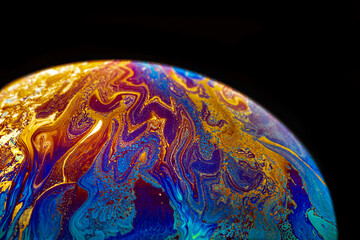Wall Mural - Virtual reality space with abstract multicolor psychedelic planet. Closeup Soap bubble like an alien planet on black background.
