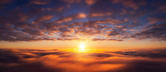 Canvas Print - Wide panorama of setting sun from the plane. Beautiful dream-like photo of flying above the clouds