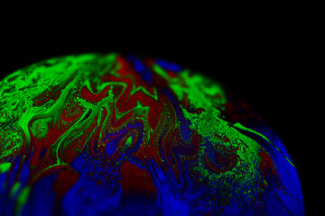 Wall Mural - Virtual reality space with abstract multicolor psychedelic planet. Closeup Soap bubble like an alien planet on black background.