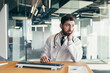 © Liubomir - The doctor is a man working at the computer, tired and has severe toothache and headache, depressed working in the clinic
