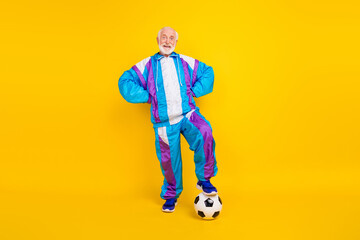 Poster - Full length photo of senior man exercise player football match regime isolated over yellow color background