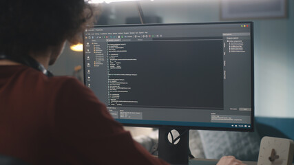 Male programmer creating code at home