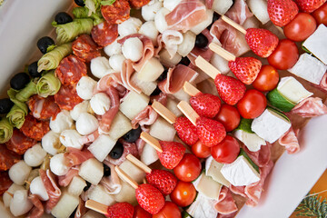 Wall Mural - Assorted canape with cheese, meat, and vegetables. Snacks in take way box. Menu food for delivery in the Coronavirus Pandemic. selective focus