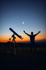 Wall Mural - Silhouette of a man, telescope and countryside under the starry skies.