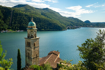 Wall Mural - Morcote, Switzerland - October 6th 2021: View over the historic church to Lago di Lugano