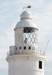 Poster - Lighthouse. Close Up of a lighthouse  with a cloudy sky in the background.