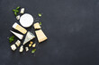 Set of cheeses: blue mold, parmesan, brie on a concrete black background.