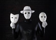 © serikbaib - two-faced man in a white mask on a black background
