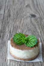 Mini Cheesecake Decorated With Mint Leaves On Wooden Rustic Table