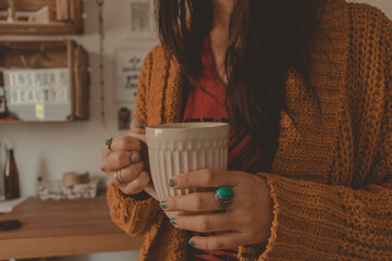 woman holding a mug of hot beverage