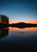 Water Ripples In Circles On Flagstaff Lake, Maine At Sunset