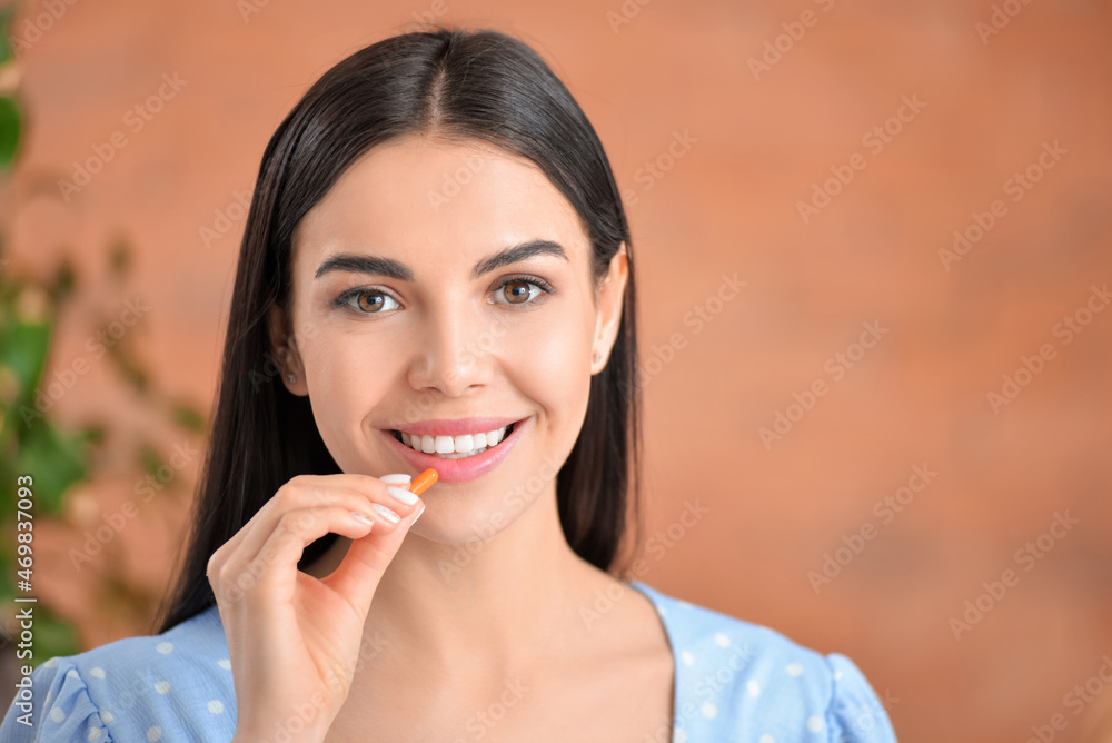 Beautiful woman taking pills at home