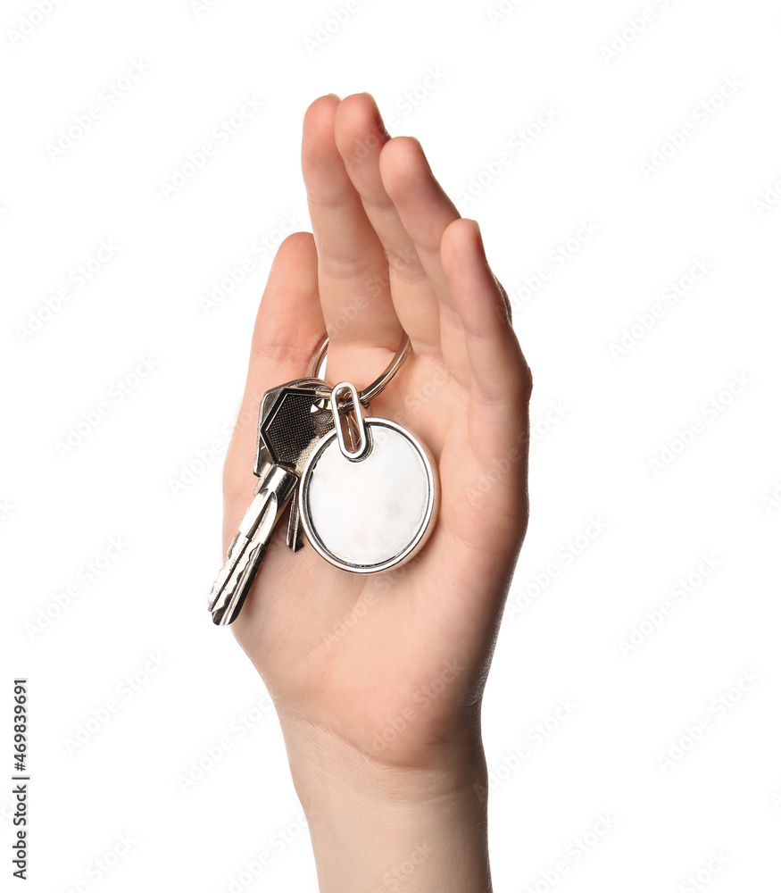 Female hand holding keys with round keychain on white background