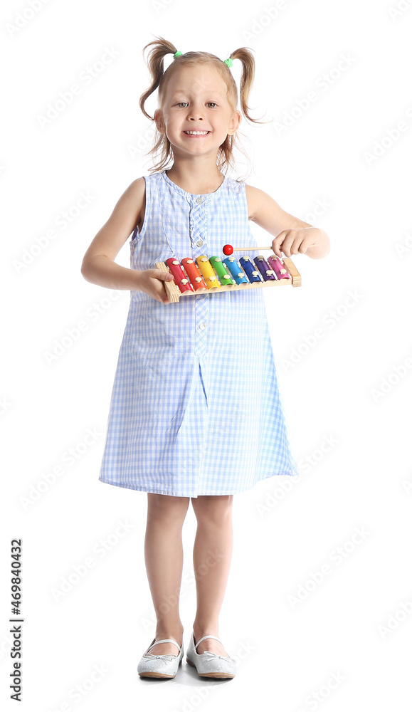 Adorable little girl with xylophone on white background