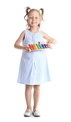 Poster - Adorable little girl with xylophone on white background