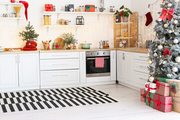 Interior of white kitchen with Christmas decor and glowing garland