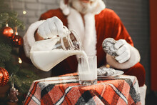 Man In Santa Claus Costume Find Milk And Cookies