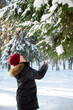 © Наталья Канищева - A teenage boy walks in a winter snow-covered forest on a sunny day and catch the snow with his mouth. Winter walks and games. A place for text. vertical photo